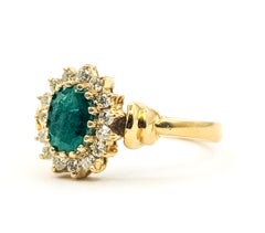 Oval Emerald & Diamond Halo Ring in 14k Yellow Gold