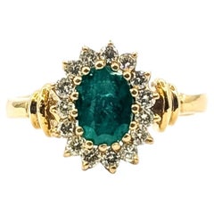Oval Emerald & Diamond Halo Ring in 14k Yellow Gold