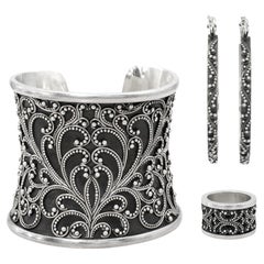 Ensemble composé d’un bracelet manchette, d’une bague et de boucles d’oreilles « Scroll » en argent sterling à motif granulé, signé Lois Hill