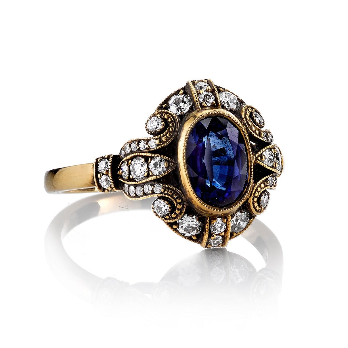 1.45ct Oval cut Sapphire diamond set in a handcrafted 18K oxidized yellow gold mounting.
