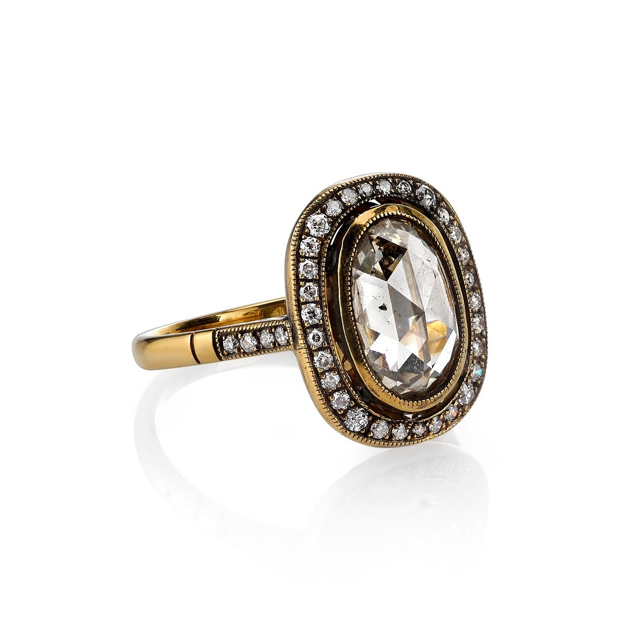 2.12ct Brown/SI oval Rose cut diamond set in a hand crafted 18K oxidized yellow gold mounting. A halo design featuring a bezel set diamond, low profile, and intricate gallery.