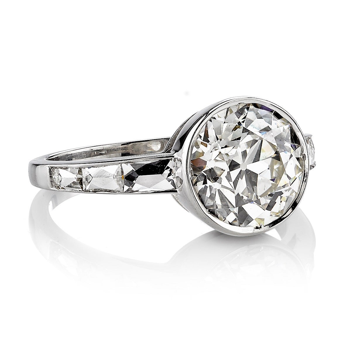 2.61ct I/SI1 EGL certified old European cut diamond set in a handcrafted platinum mounting. A contemporary design that is bezel set and features beautiful French cut accents.