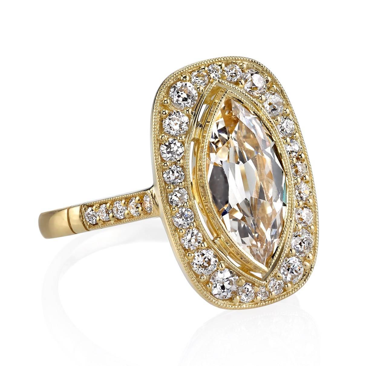 1.59ct N/VS2 GIA certified Marquise cut diamond set in a handcrafted 18k yellow gold mounting. A unique halo design featuring a bezel set diamond, low profile, and intricate gallery.