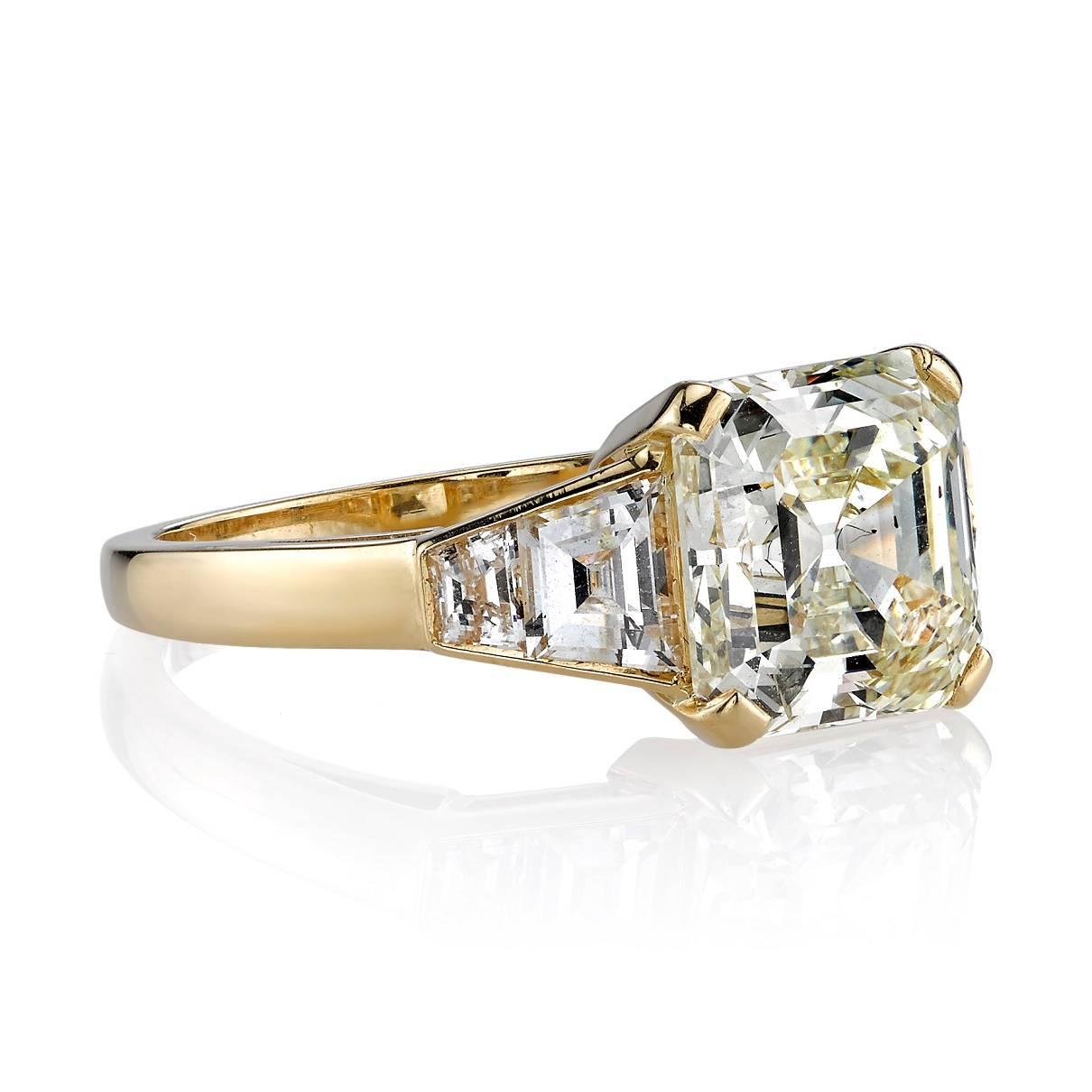 3.45ct N/SI1 Asscher cut diamond EGL certified and set in a handcrafted 18k yellow gold mounting. A clean and classic design featuring trapezoid accent diamonds.