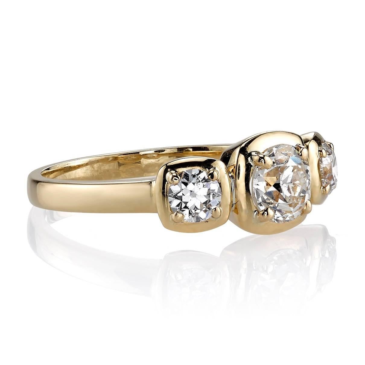 0.69ct J/VS1 EGL certified old European cut diamond with 0.36ctw old European cut side diamonds set in a handcrafted 18k yellow gold three stone ring.