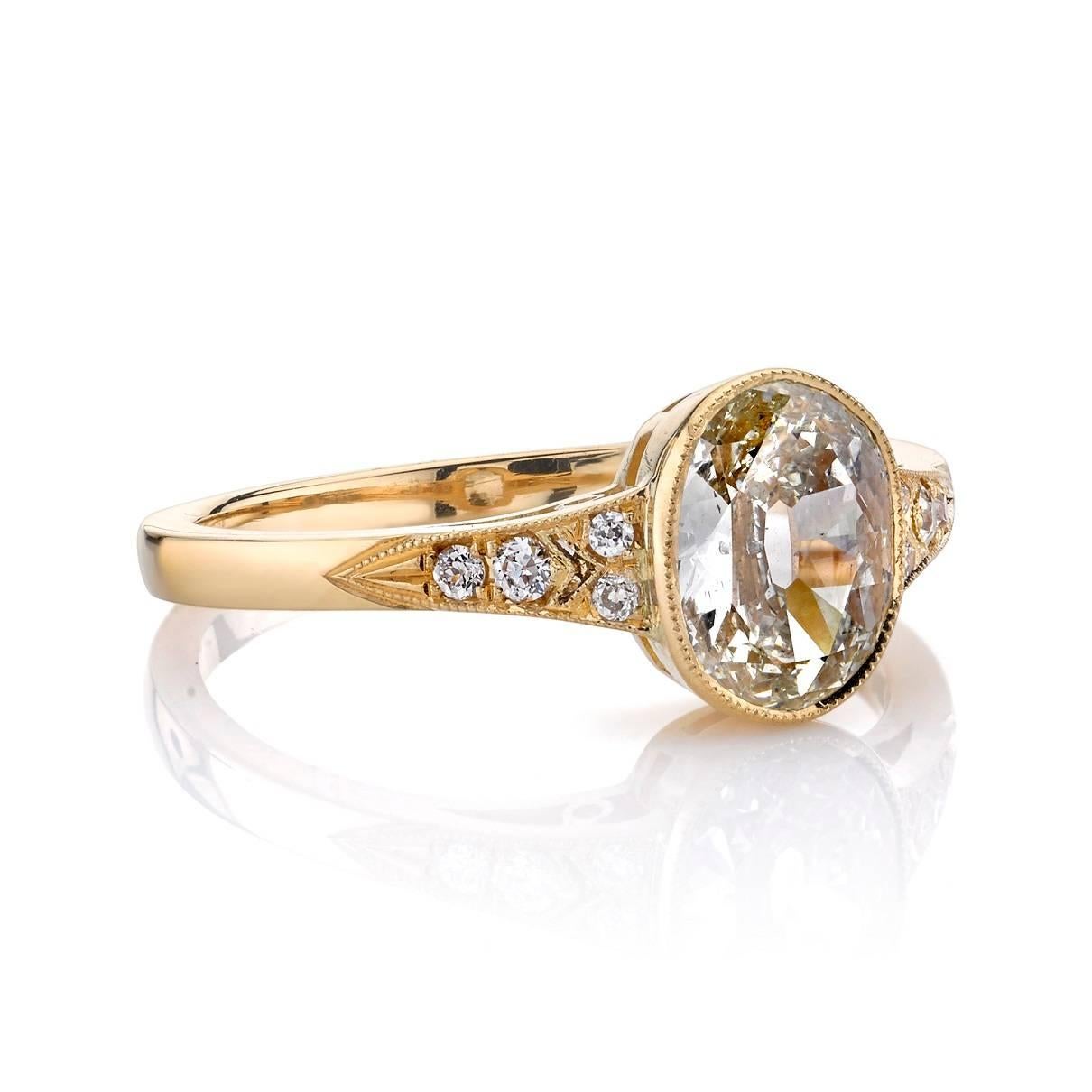 1.08ctw K-L/SI2 Oval cut diamond bezel set in a handcrafted 18k yellow gold mounting. 0.08ctw old European cut accent diamonds line both sides of the shank.

Ring is a size 6 and can be sized to fit. 