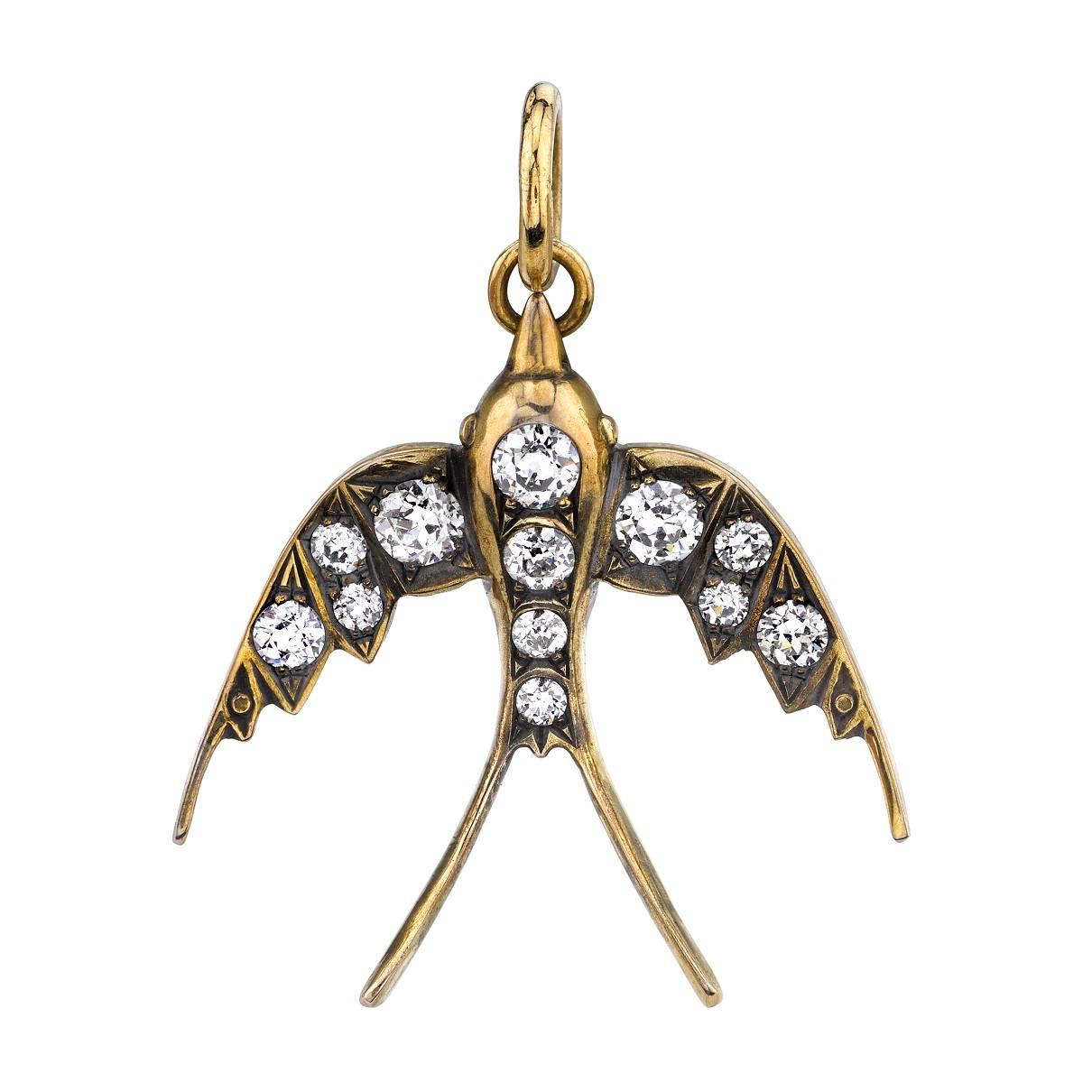 0.89ctw old European cut diamonds set in a handcrafted 18k yellow and white gold Swallow charm.  Includes 24