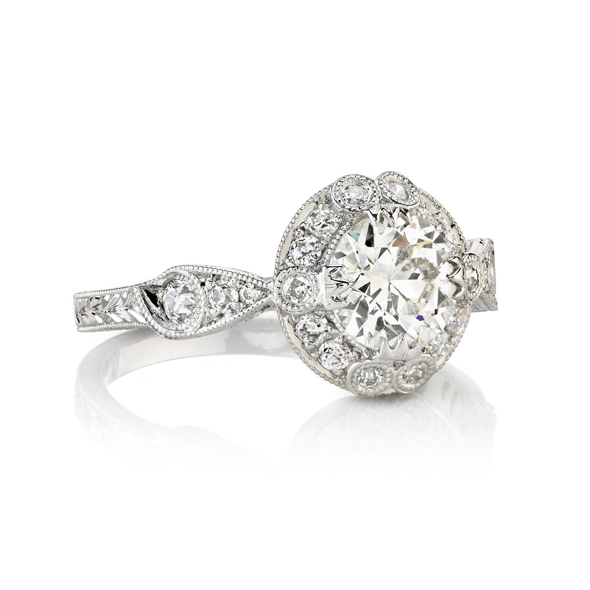 0.90ct G/VS1 EGL certified old European cut diamond set in a handcrafted platinum mounting. A classic Edwardian design that features a feminine halo, hand engraving and filigree.
