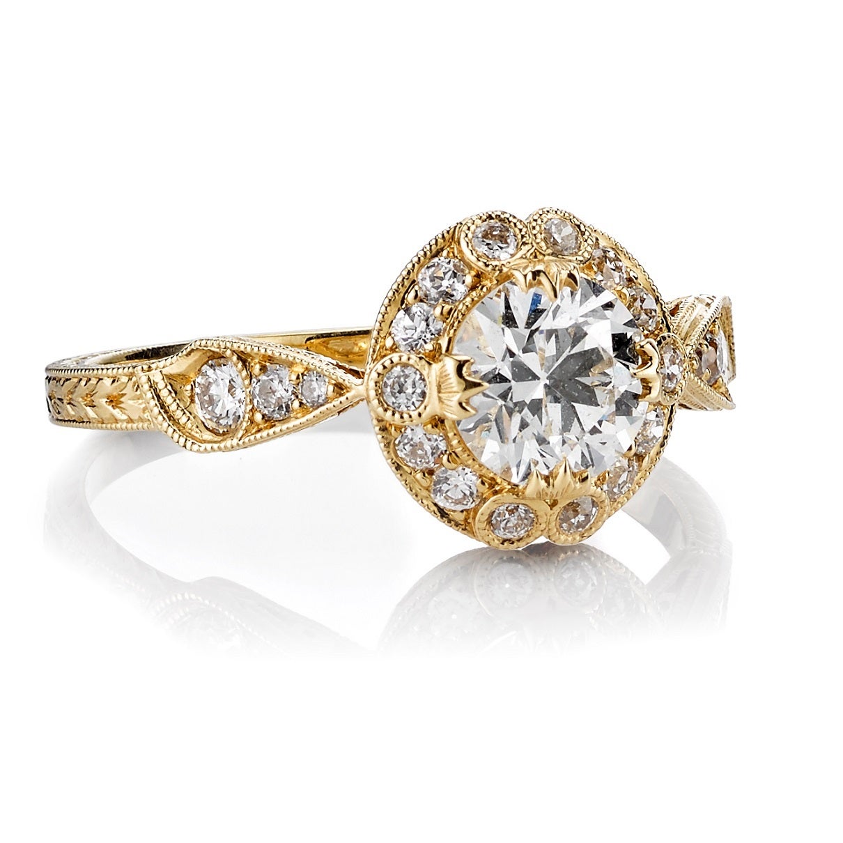 0.72ct F/SI1 EGL certified old European cut diamond set in a handcrafted 18K yellow gold mounting. A classic Edwardian design that features a feminine halo, hand engraving and filigree.