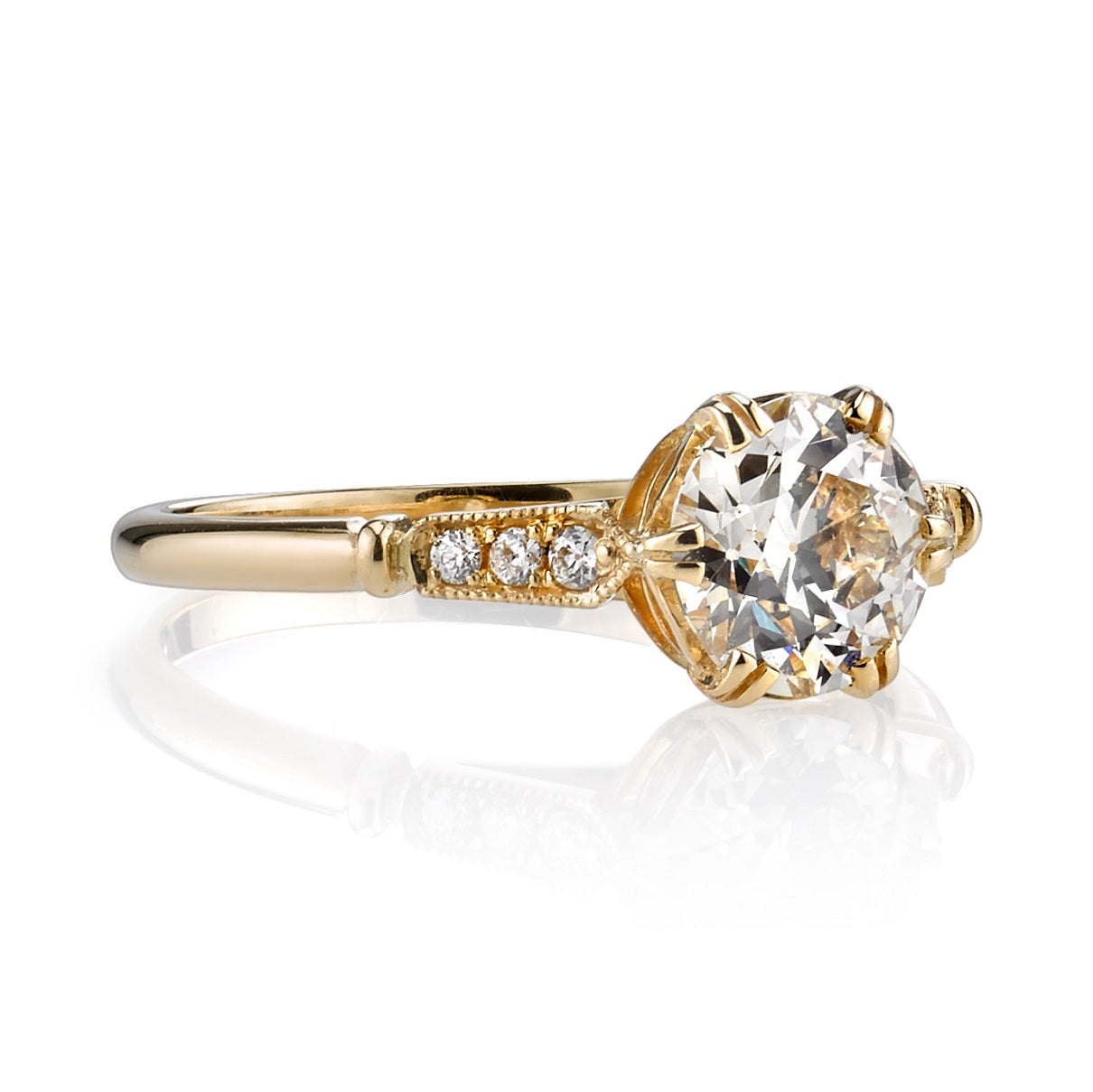 1.07ct K/VS1 EGL certified old European cut diamond set in a handcrafted 18K yellow gold mounting. A classic solitaire design featuring a detailed gallery and tapering accent diamonds.