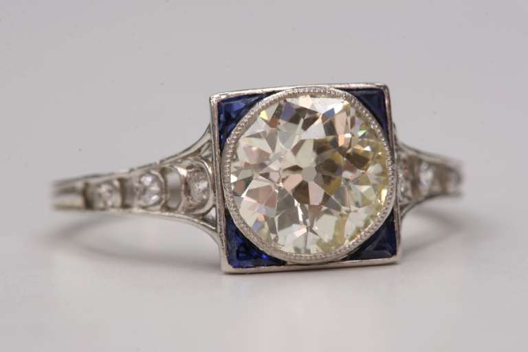 1.49ct PQ/SI1 old European cut diamond with sapphire accents set in a vintage platinum mounting. Circa 1920
