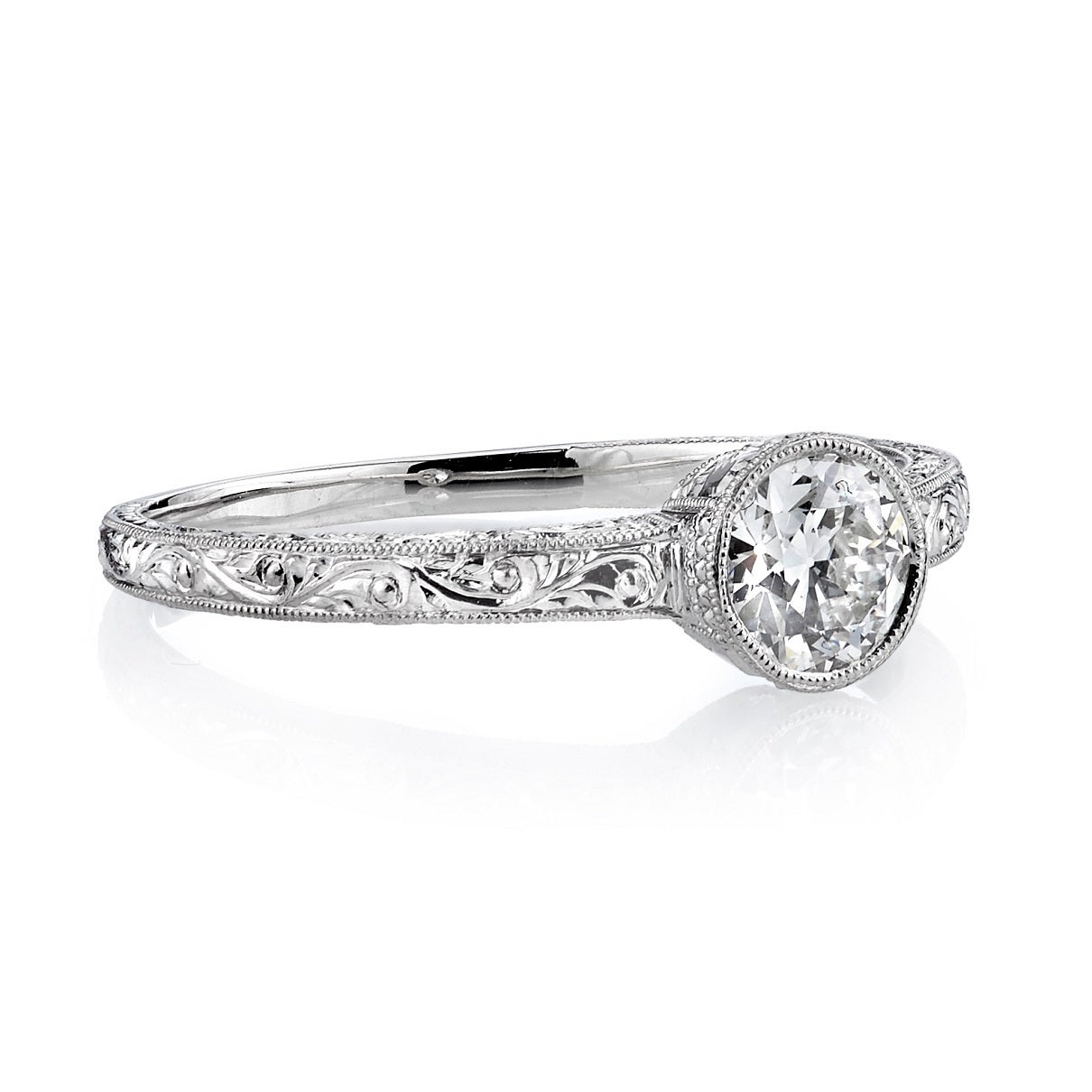 0.45ct G/VS2 GIA certified old European cut diamond set in a handcrafted platinum mounting. A sweet bezel set engagement ring featuring an engraved band.