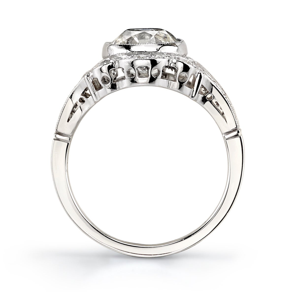 2.40ct M/SI1 EGL certified vintage Cushion diamond set in a handcrafted platinum mounting. An Edwardian inspired design that features a low profile, scalloped edges, and a beautiful detailed band.