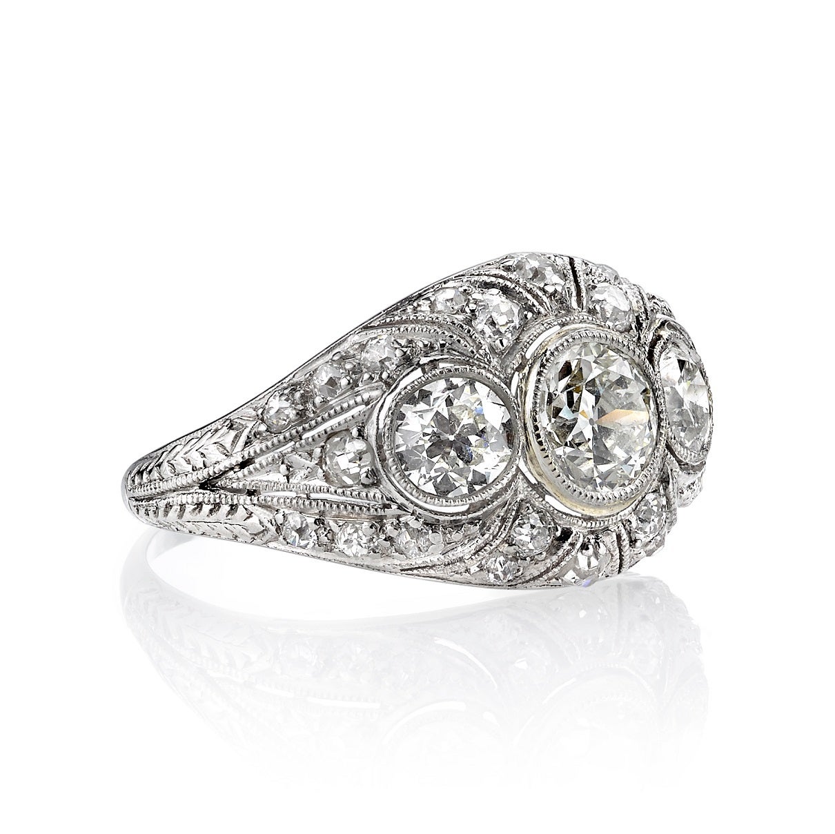 1.95ctw HI/VS old European cut diamonds set in a vintage platinum mounting. Circa 1920. A romantic three stone 