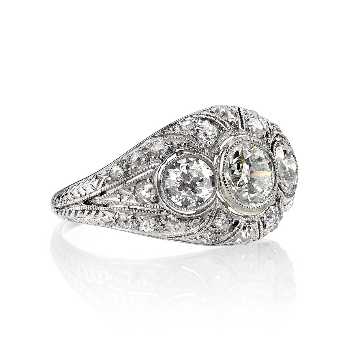 1.95ctw HI/VS old European cut diamonds set in a vintage platinum mounting. Circa 1920. A romantic three stone 