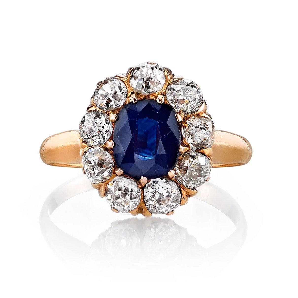 1.00ct Sapphire with 1.10cttw old Mine cut diamond accents set in a vintage 14k yellow gold mounting. Circa 1915.