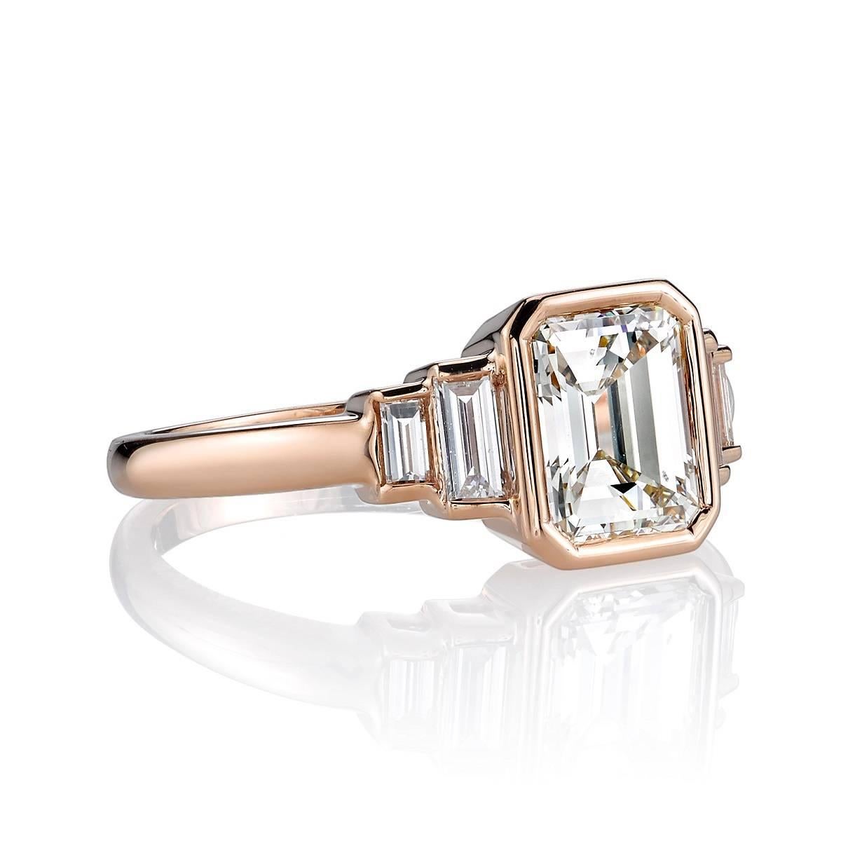 1.53ct L/VS1 GIA certified Emerald cut diamond set in a handcrafted 18k rose gold mounting. A classic and sleek design featuring bezel set diamonds and baguette accents.