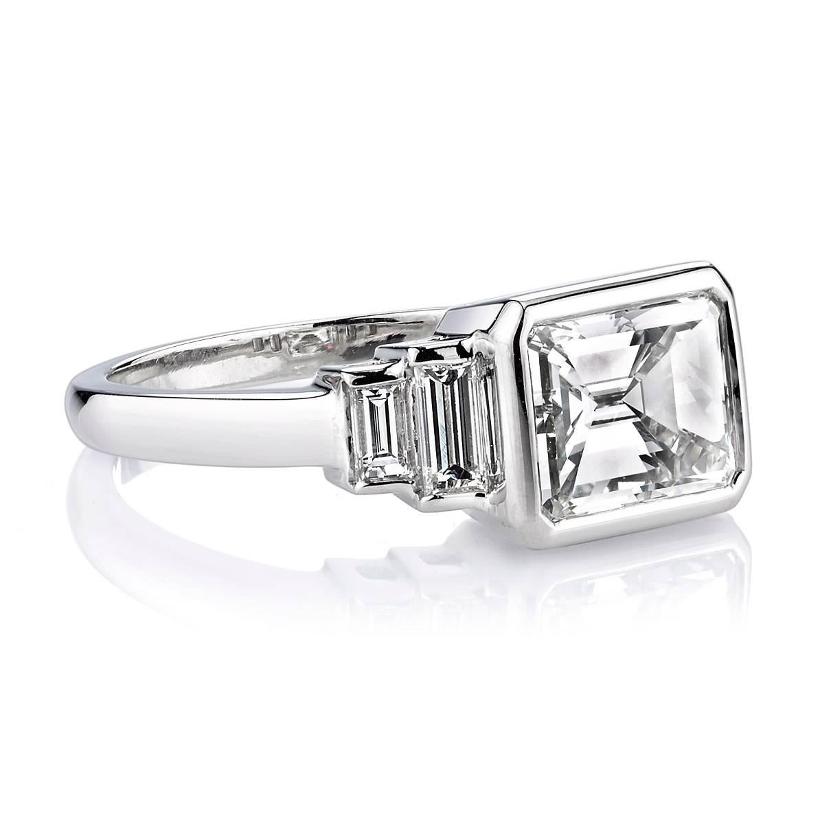 2.40ct J/VVS2 GIA certified Emerald cut diamond set in a handcrafted platinum mounting. A classic and sleek design featuring bezel set diamonds and baguette accents.
