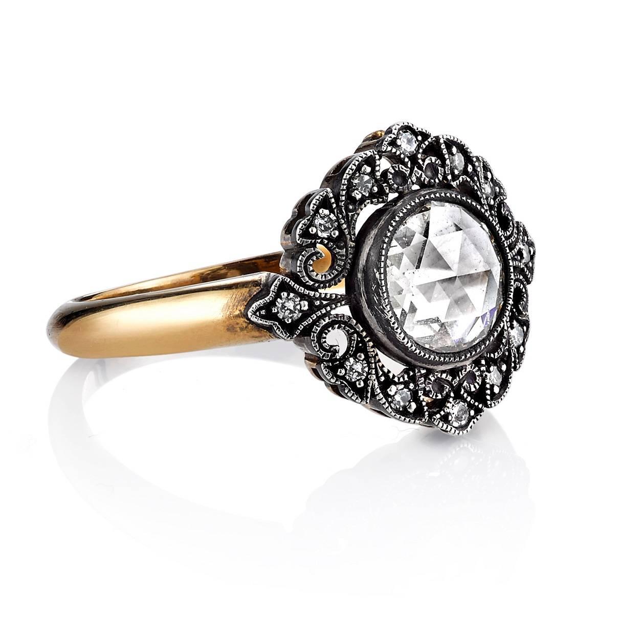 0.85ct G/VS2 EGL certified Rose cut diamond set in a handcrafted 18K oxidized yellow gold and silver mounting. A Victorian inspired design featuring a bezel set diamond, two toned metal and delicate halo.