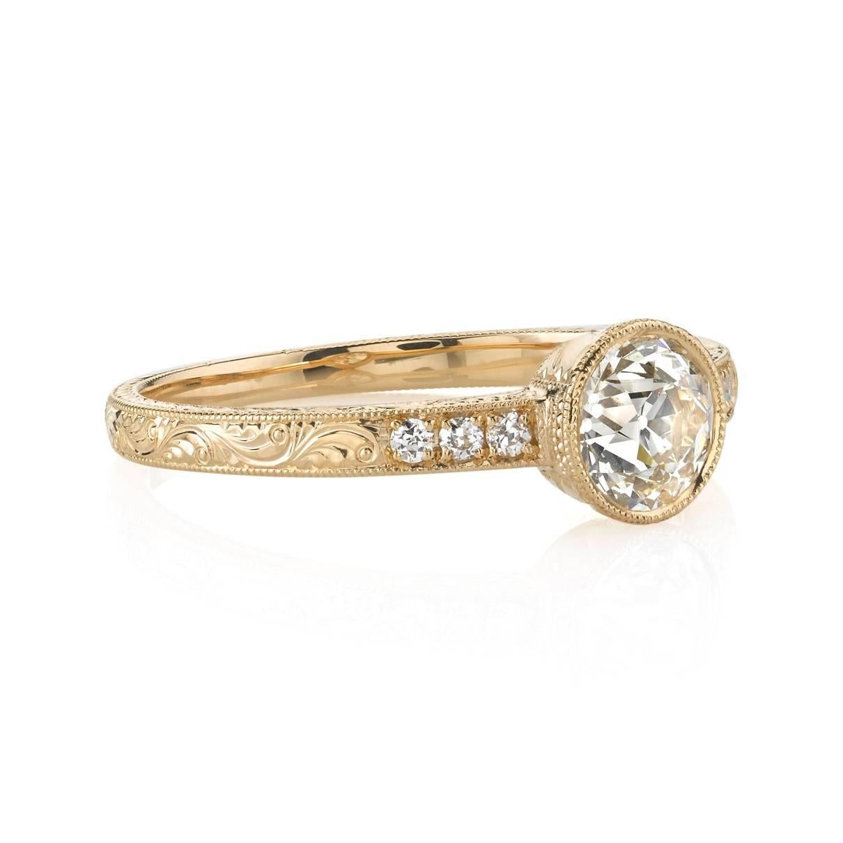 0.63ct H/SI1 old European cut diamond EGL certified and set in a handcrafted 18k rose gold mounting.  A sweet bezel set engagement ring featuring an engraved band with diamond accents.