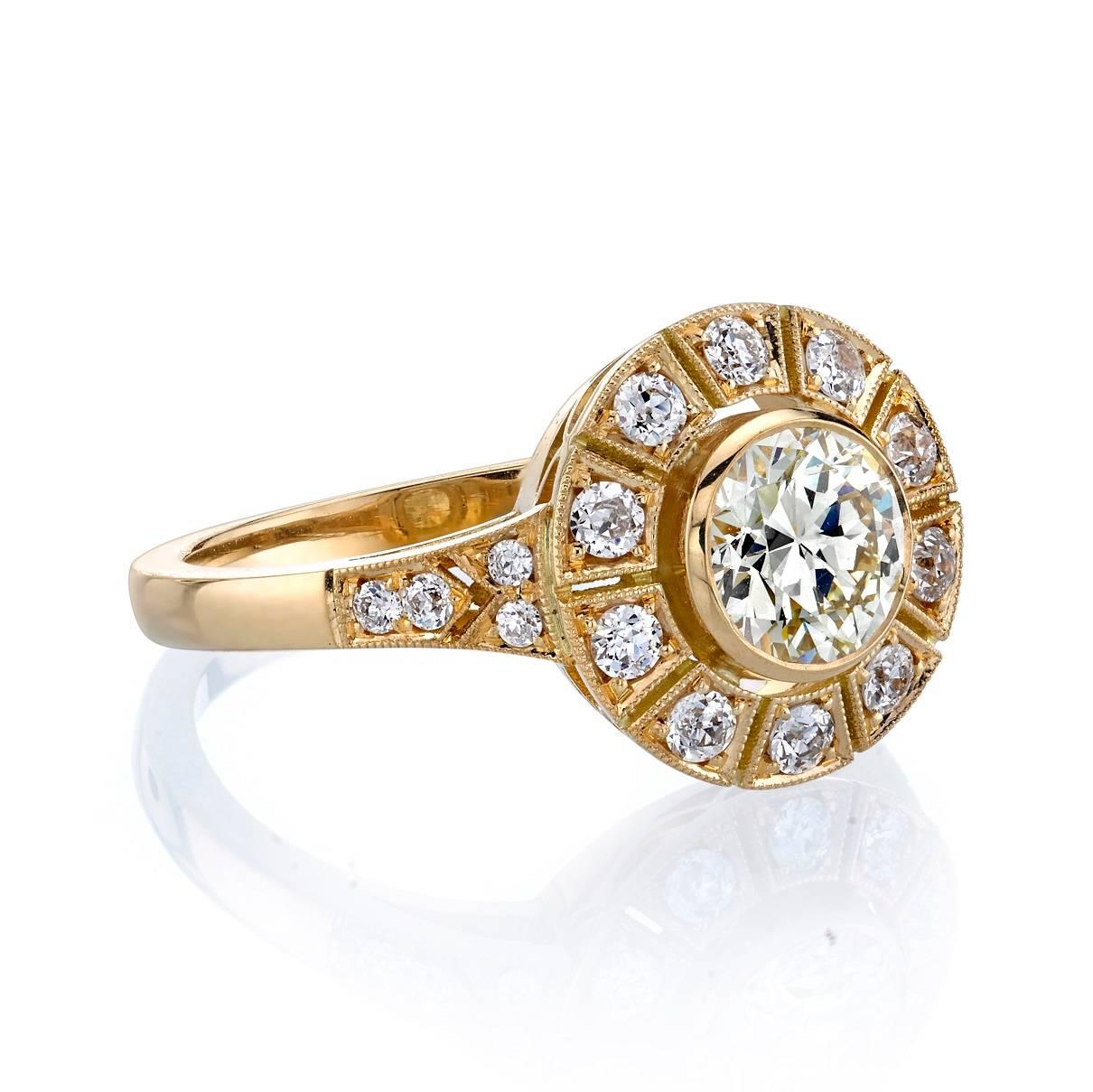 0.75ct QR/VS old European cut diamond set in a handcrafted 18k yellow gold mounting.  A gorgeously stylized surround gives this piece a unique Art Deco look.