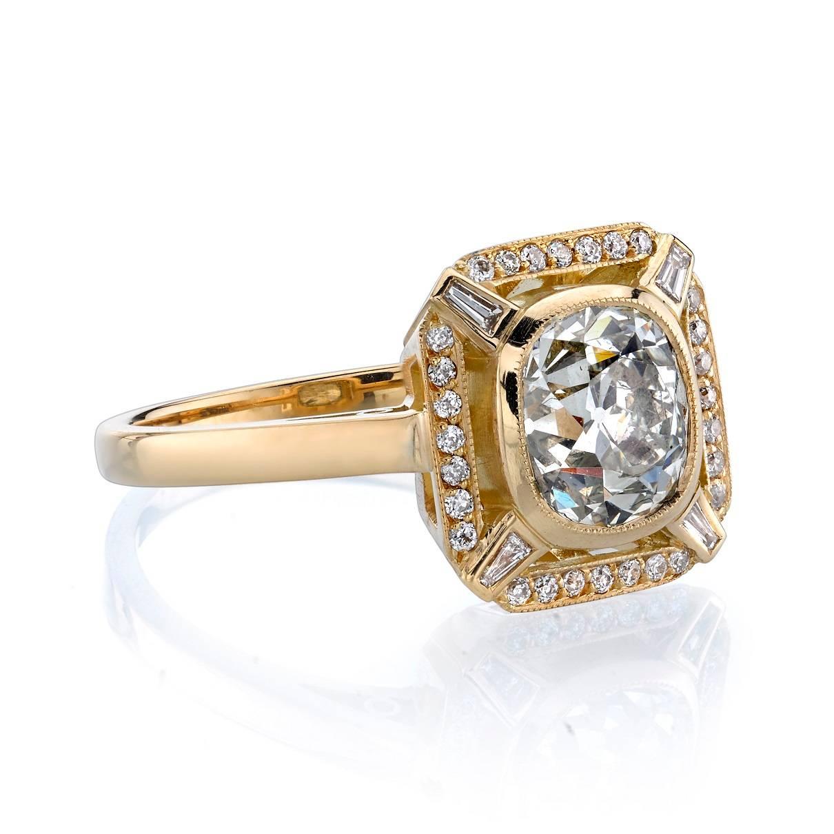 1.82ct J/SI2 Cushion cut diamond EGL certified and set in a handcrafted 18k yellow gold mounting.  This luxe ring gives a fresh and modern take on the diamond surround.