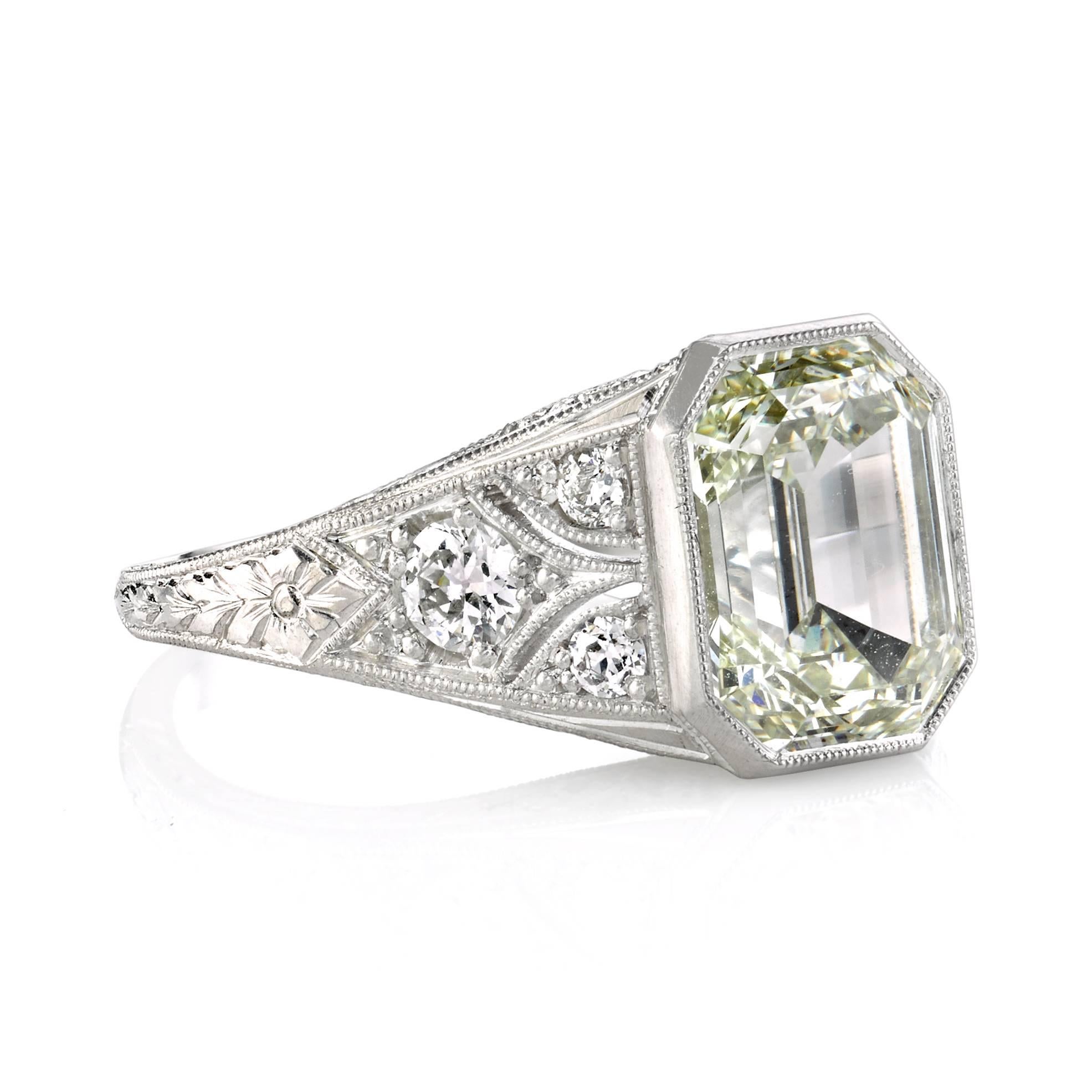 3.06ct M/VS2 HRD certified Emerald cut diamond set in a handcrafted platinum mounting. An Art Deco design featuring a beautiful detailed gallery, low profile, and tapering band.