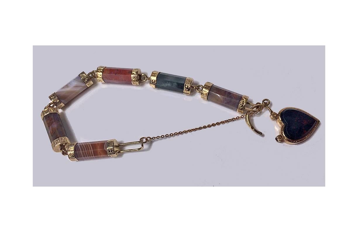 Scottish Gold Agate padlock bracelet with engraved links, C.1875. The octagonal gold (tested 9K) engraved foliate thistle mounts each set with a varied colour octagonal facetted cylindrical agate, terminating with bloodstone heart padlock clasp.