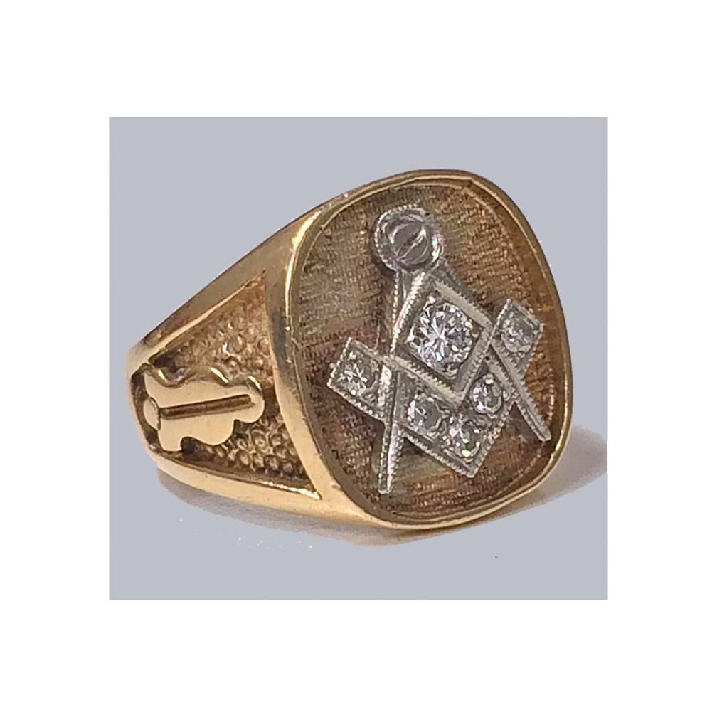 Diamond Masonic Ring, 10K. The Ring set at the top with diamond encrusted masonic emblem against stippled background. Total Diamond Weight: Approximately 0.15 ct. Stamped 10K on interior of shank. Total Item Weight: 7.1 gm. Ring Size: 7 (can be
