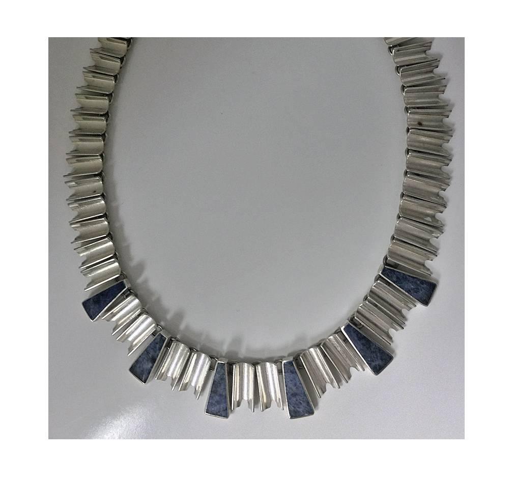 Vintage Mexican Sterling Silver Necklace and matching Bracelet, C.1980. The Necklace and Bracelet in Monteros manner of an art deco bold chevron cleopatra style. Set with concave and isosceles trapezium links inlaid with blue grey chalcedony . Each