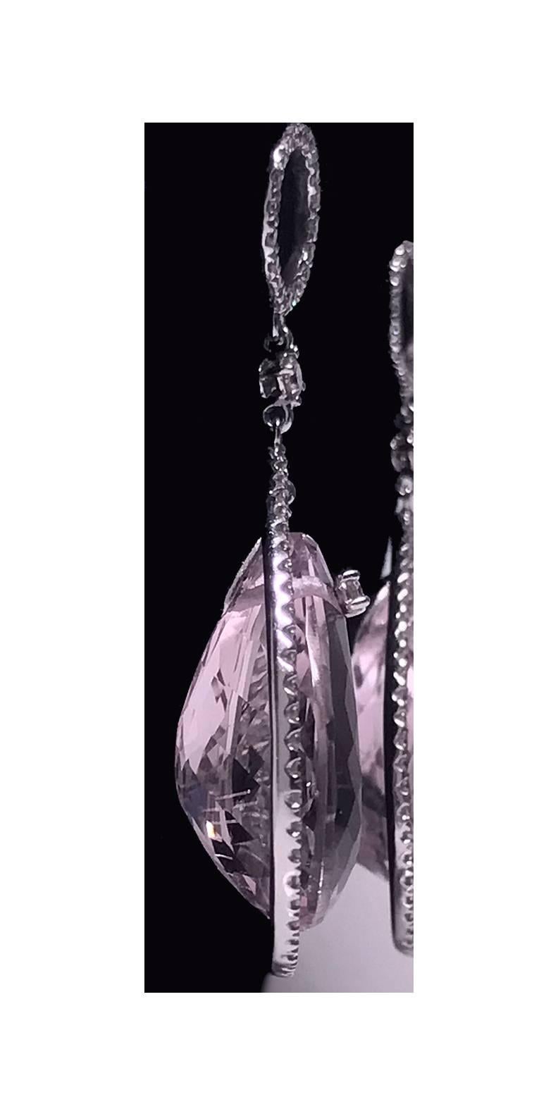 Pair of Diamond and Kunzite drop Earrings mounted in Platinum (18K backs). Each suspending a large kunzite briolette, gauging approximately 23 x 13.2 x 11 mm set at the top with a small round brilliant cut diamond, the surround mount diamond set,
