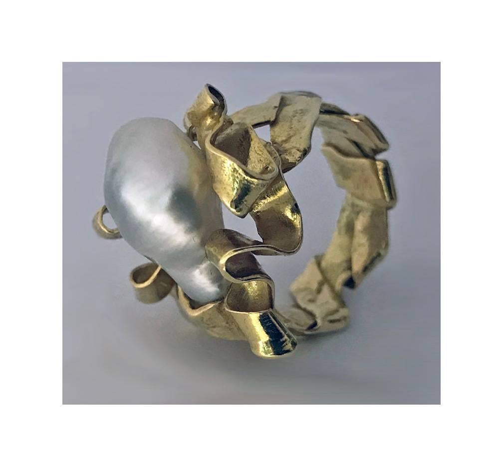 20th century 18K abstract Ring, English hallmarks, C.1980. The ring with a baroque pearl, set in within a rippled gold scroll fold like mount continuing around shank. Top of ring measures: 0.75 x 0.75 inches. Item Weight: 13.28 grams. Ring size: 8. 
