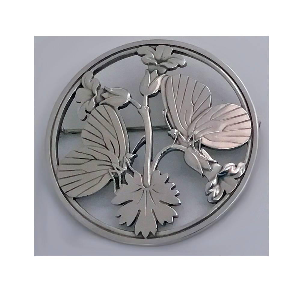 Georg Jensen Sterling Silver Butterfly Brooch, 20th century. The brooch of circular shape with flower and butterfly design, number 283. Back stamped with Jensen hallmarks, second half of 20th century. Overall weight 27.27 gm. Diameter: 2.125 inches.