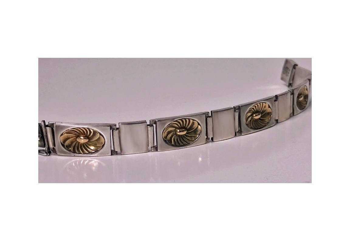 Georg Jensen Sterling bracelet, designed by Henry Pilstrup. The bracelet with alternate rectangular gold over sterling lotus links and square polished sterling links respectively. The `lotus’ design was first created by Henry Pilstrup in
