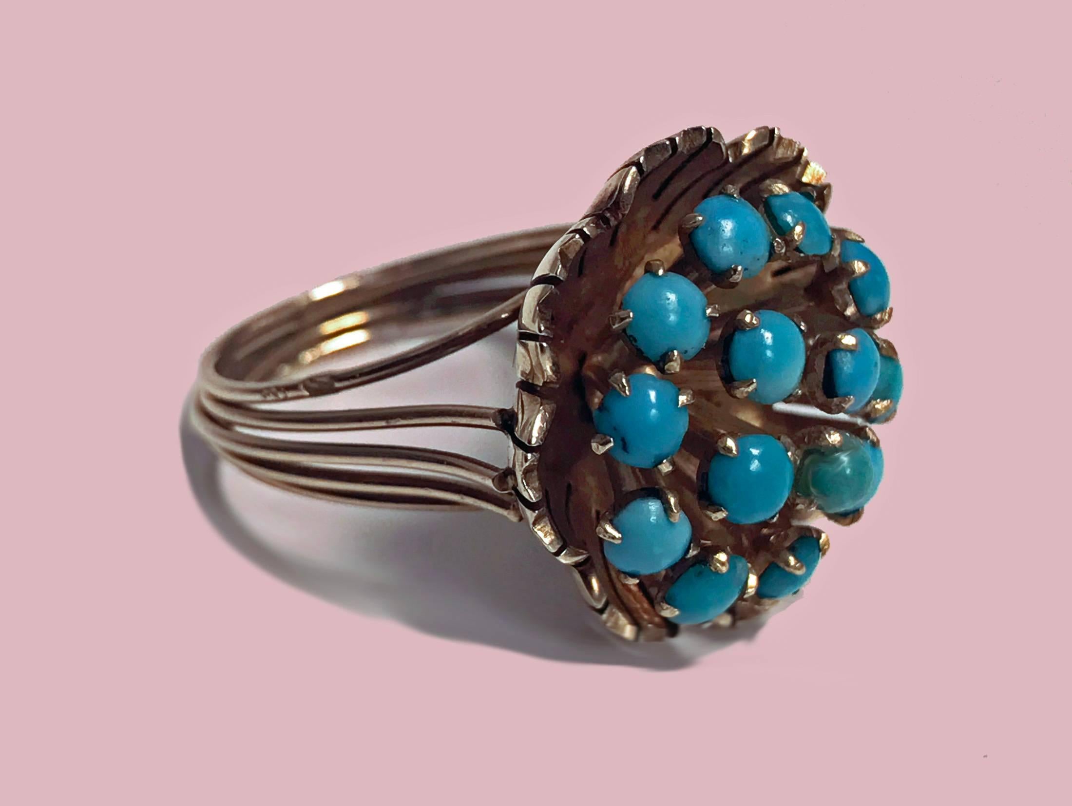 14K Turquoise Cluster Ring, butter cup design, C.1960. The large cluster set with 14 cabochon turquoise, gauging 3.00 to 3.50 mm, greenish blue, slight variance in stones, all claw set within a buttercup design, split gold wire shank. Stamped 14K