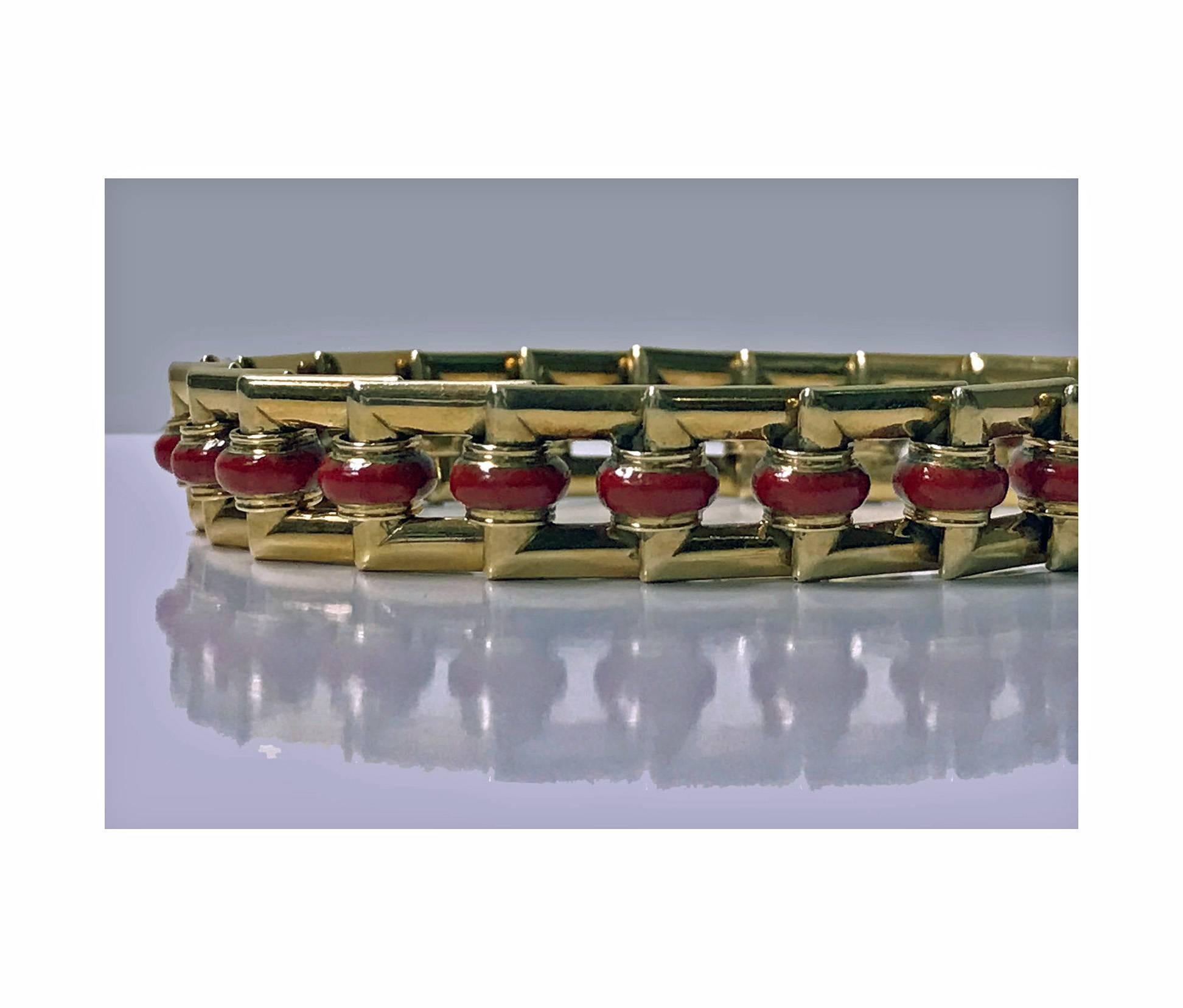Art Deco 18K Carnelian Bracelet, C.1930. The Bracelet with overlapping open rectangular links each with orange red carnelian rondelle, terminating with tongue and box clasp fastener. Length: 7.25 inches. Item Weight: 40.32 grams.