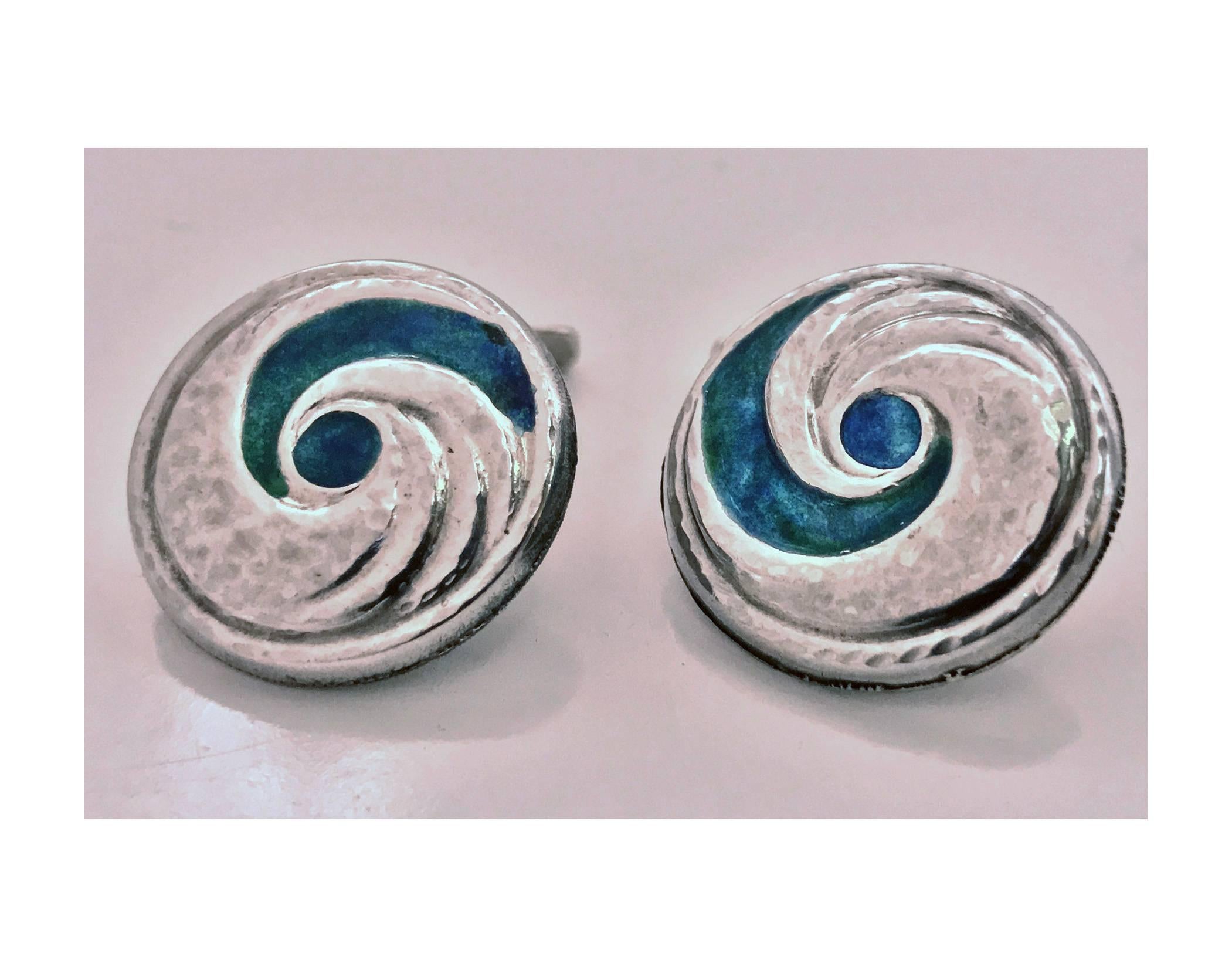 Pair Liberty & Co Archibald Knox designed Enamel Cufflinks, Birmingham 1902-4. The circular slightly concave cufflinks with swirl hammered silver and green, blue, turquoise enamel. Chain and hemi rectangular bar fitments. Full Liberty marks to