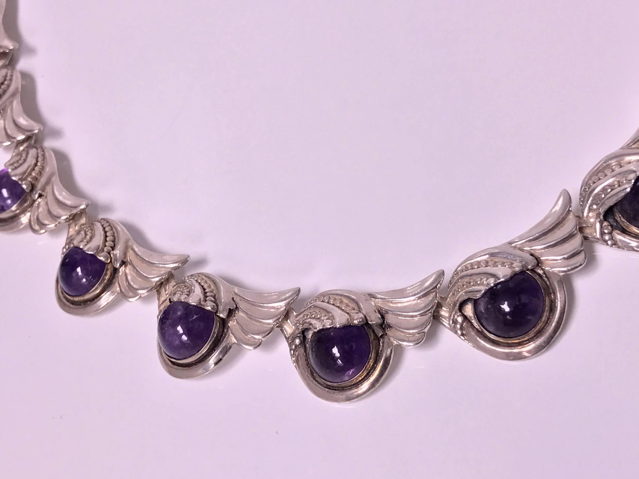 Margot De Taxco Sterling Silver Amethyst Necklace, C.1950. Stylized design, amethyst cabochon link, gauging 11 mm, stamped Sterling Made in Mexico Margot de Taxco 5240, eagle 16 mark. Length: 15.25". Weight: 75.4 gm. American, Margot Van
