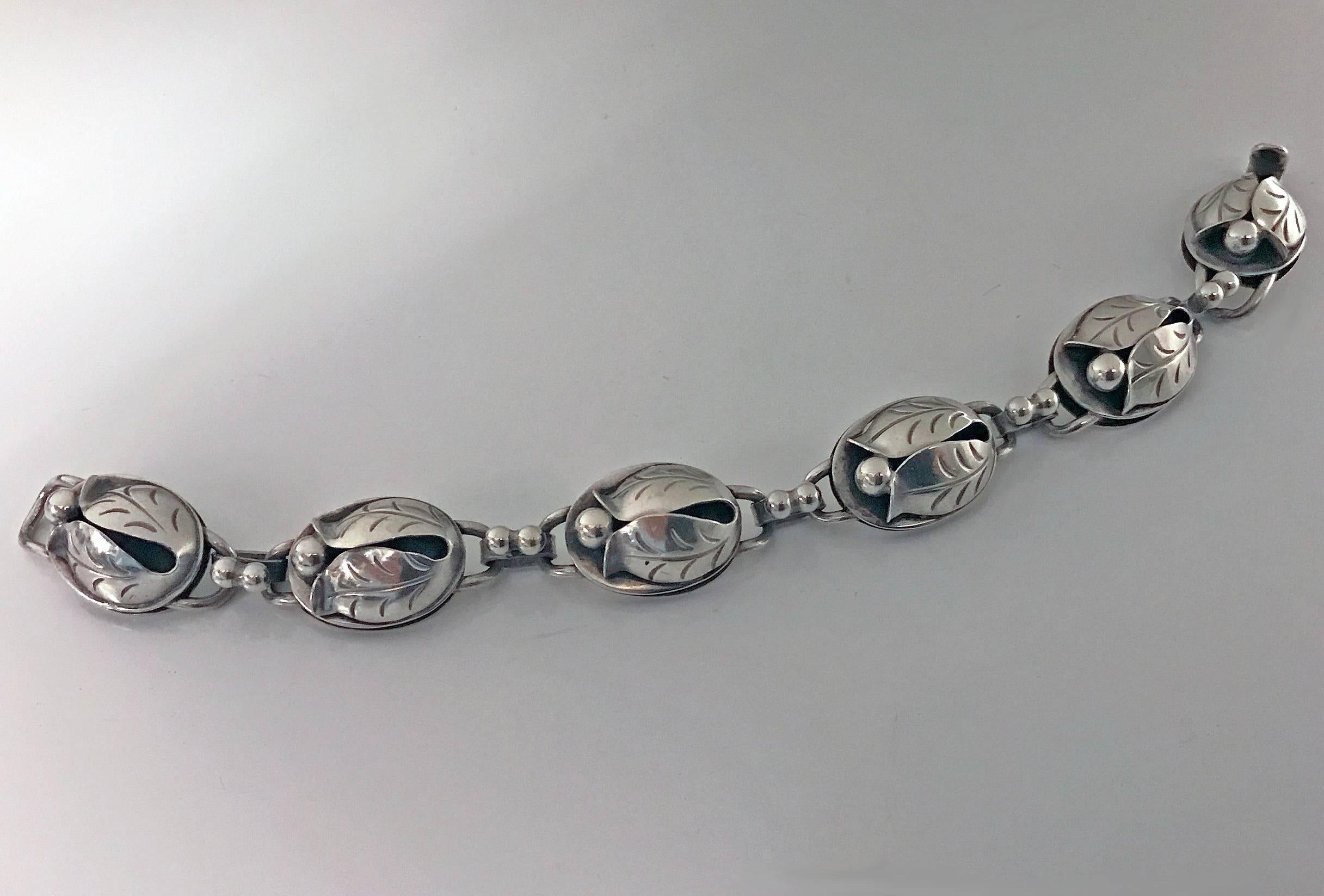 Georg Jensen Sterling Blossom Bracelet, C.1950.The Bracelet with hinged open stylised bud blossom links, plain polished links between, Georg Jensen hand wrought Sterling USA marks to reverse and design number 118. Length: 7 inches. Item Weight: