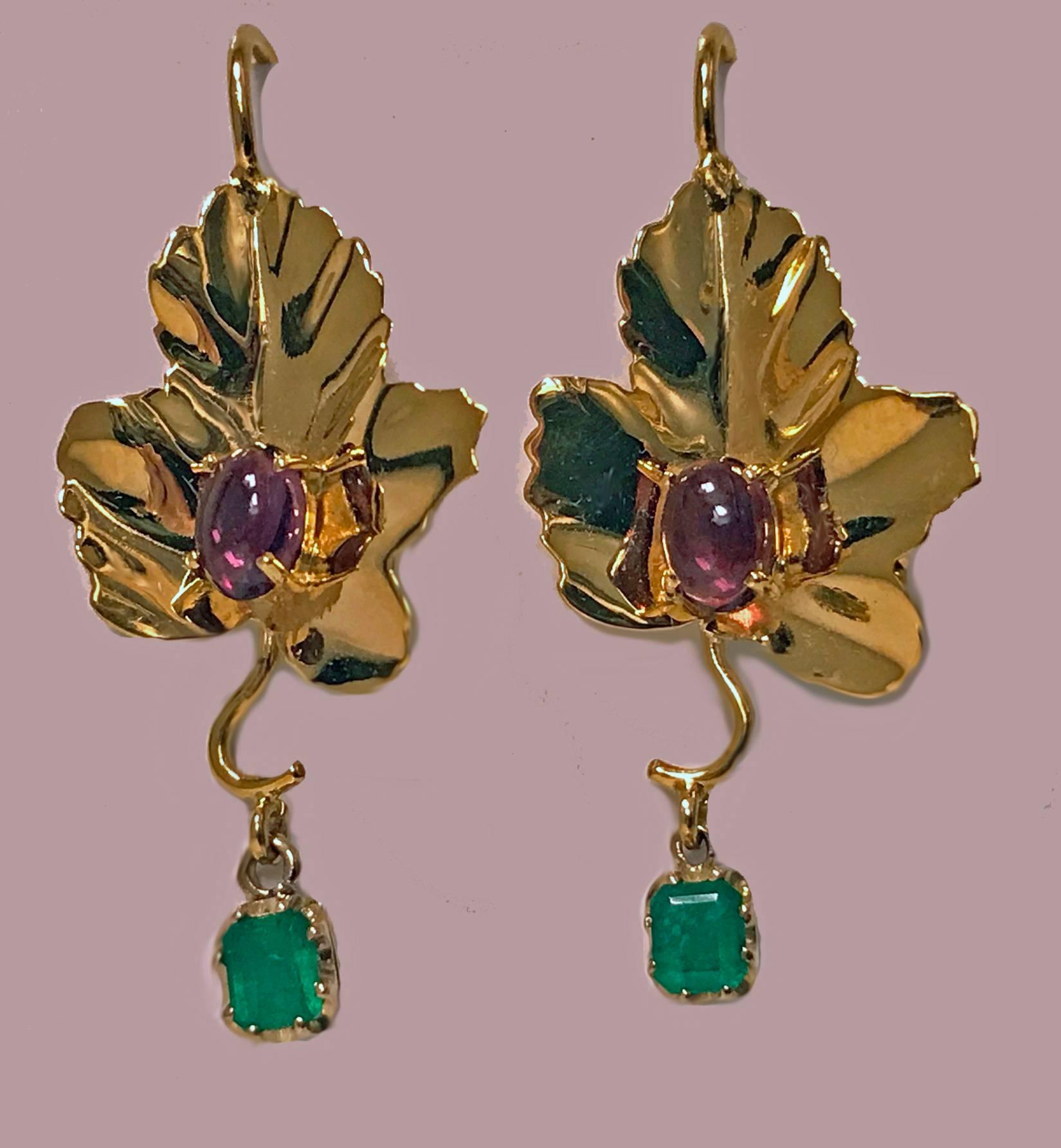 Pair of 18K Emerald and Garnet Maple Leaf drop Earrings, 20th century. The handmade Earrings each with large maple leaf set with cabochon medium pink garnet and suspending an emerald cut green emerald, total approximate weight of 0.70 ct. Hook