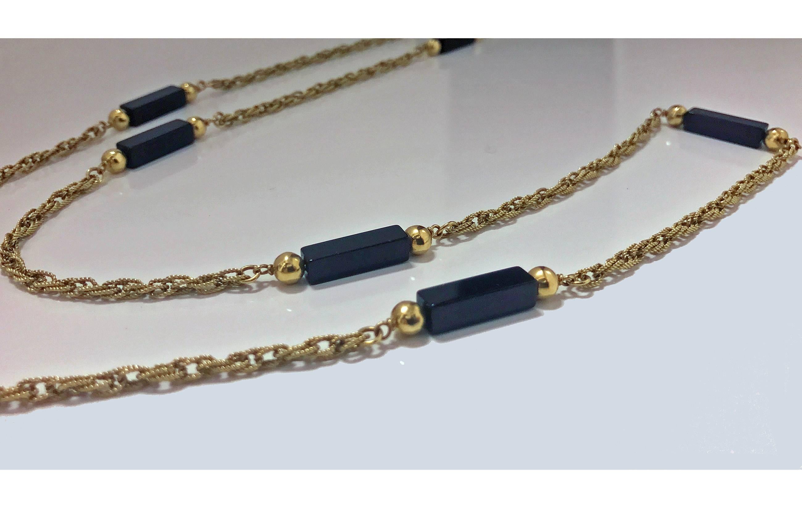 18K black onyx Necklace Chain, 20th century. The intertwining rope link chain interspaced with eight black onyx bar links accented on either side with gold ball, box link clasp, safety catch attached. Stamped 750 with trademark pine tree. Length: 36