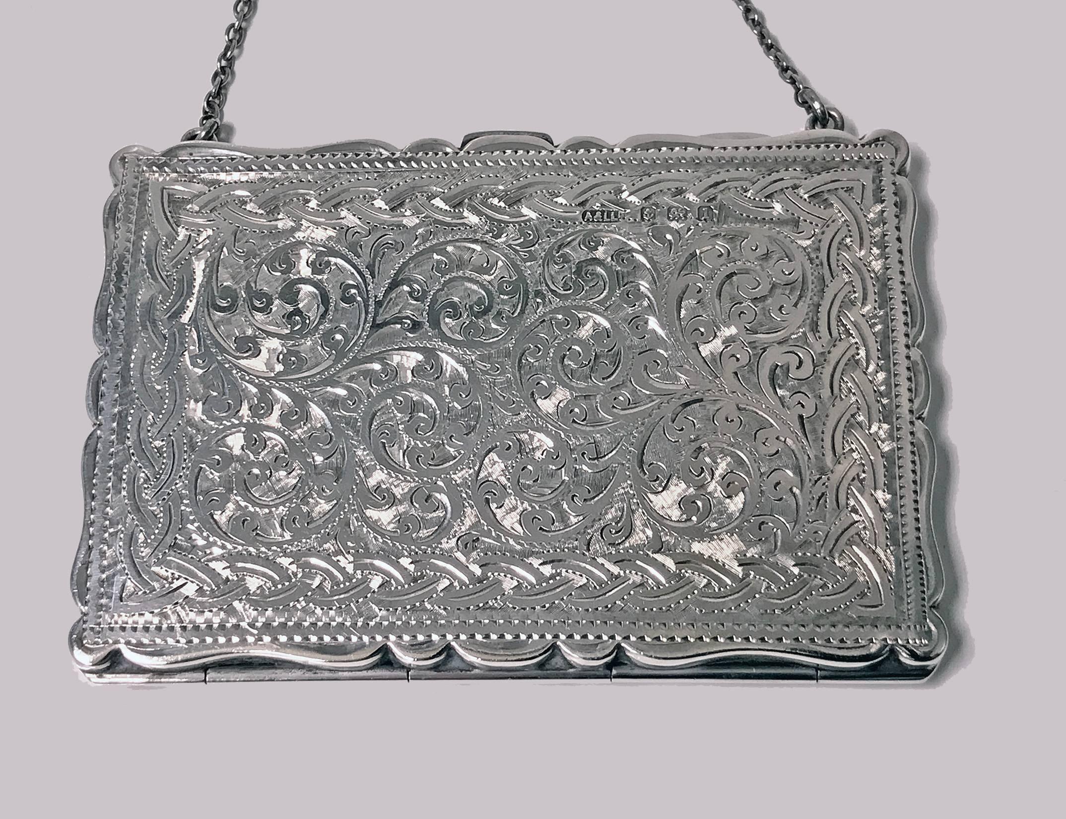 Antique Silver Card Case in form of purse, Birmingham 1910, Adie & Lovekin Ltd. The case of hinge and thumb piece design, richly engraved scroll foliage decoration, light monogram possibly MJ. Measures: 3.75 x 2.625 inches (excluding chain). Weight: