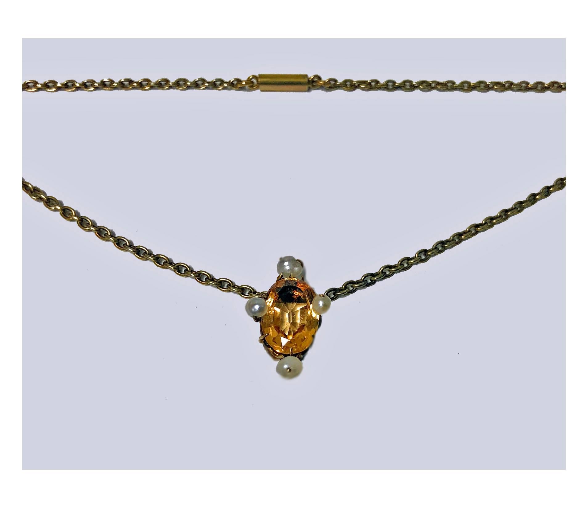 Antique Imperial Topaz, and Pearl, 15K (tested) Necklace pendant English C.1890. The Necklace suspending  imperial yellow orange oval facetted topaz bordered with four fresh water pearls and surmounted. Drop: 1inch. Length: 18.5 inches. Item Weight: