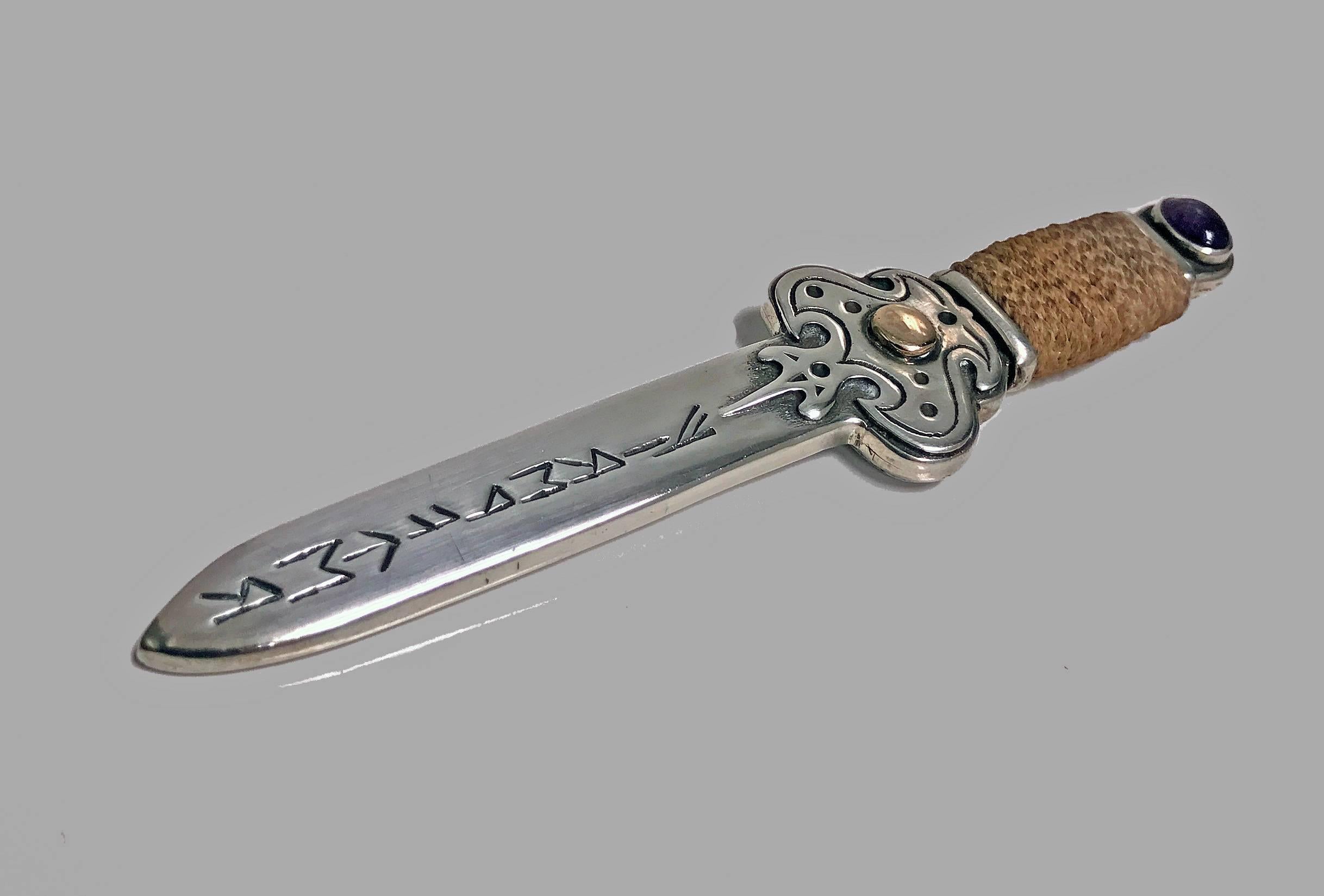Rare wonderful quality heavy Sterling Silver, Gold and Amethyst Letter Opener, engraved with elements of Runes for Air, Fire, Water and Earth, probably Scandinavian, C.1910. The letter opener in the form of a small sword with braided grip, cross