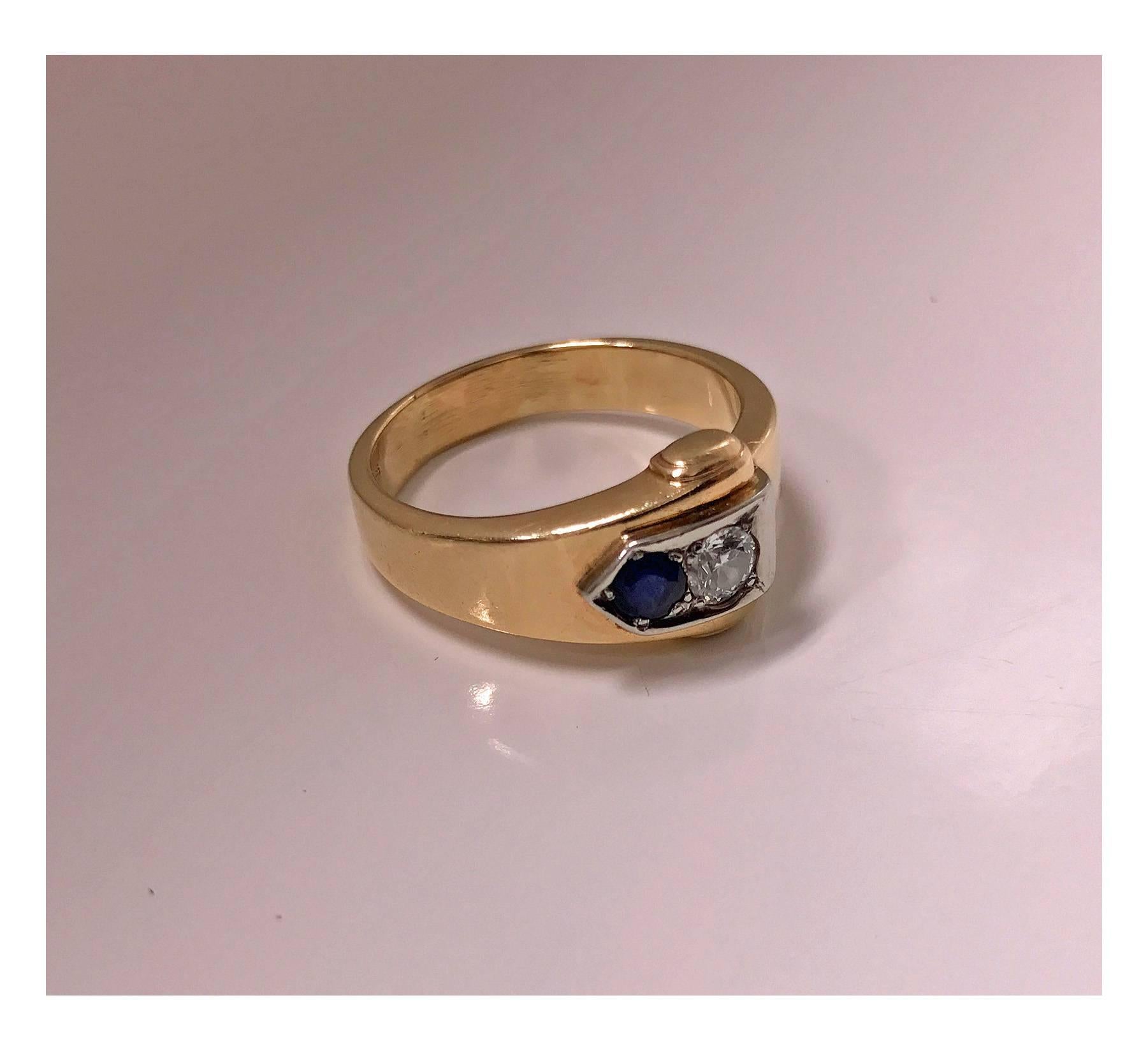 Sapphire and Diamond Ring mounted in 18K and 10K Gold, 20th century. The Ring of a buckle design, the `clasp set with a round european cut diamond, approximately 0.20 ct, approximately SI clarity, approximately I colour and round facetted medium,