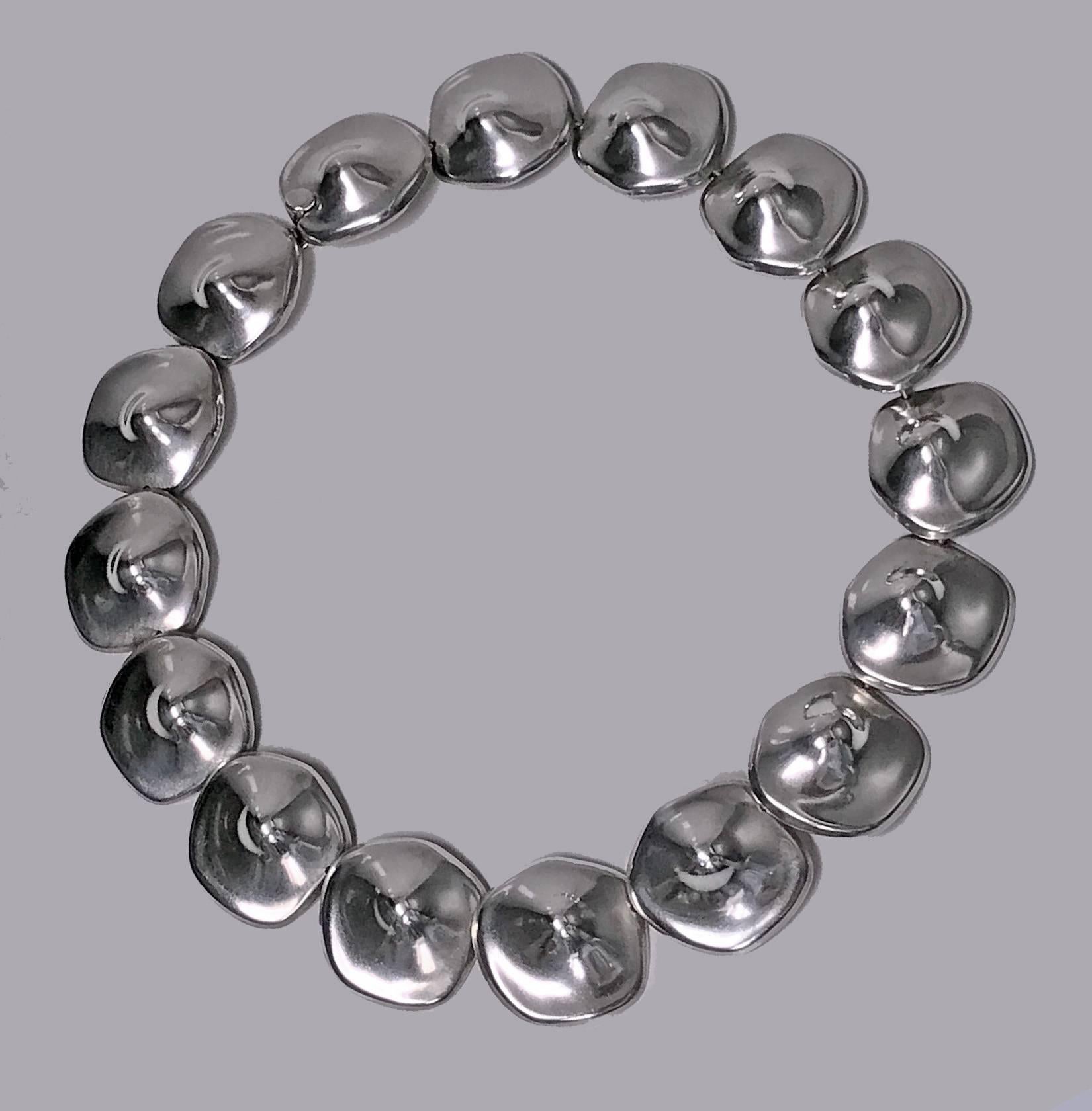 Mexican Sterling abstract Necklace, C.1980. The Necklace comprising sixteen large asymmetrical undulating `nipple’ type links, plain polished sterling, terminating with tongue box clasp conforming to link. Length: 19 inches. Stamped Mexico Sterling