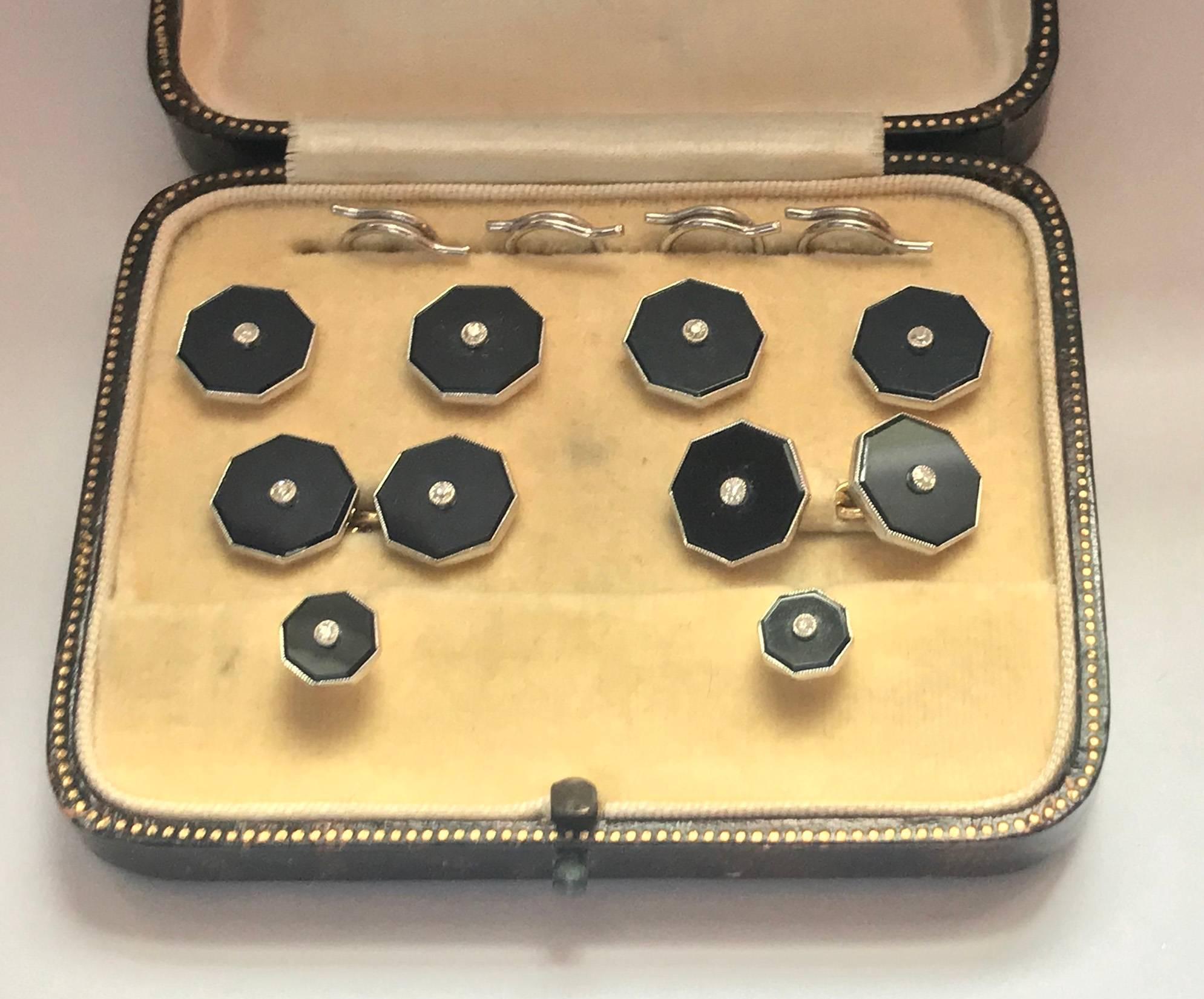 Set of 18K, Platinum, Onyx and Diamond gold Studs and links Tuxedo Set in fitted box, English C.1920. The studs of octagonal shape, each milligrain set in the center with a round faceted diamond and black onyx surround, the Cufflinks with chain link