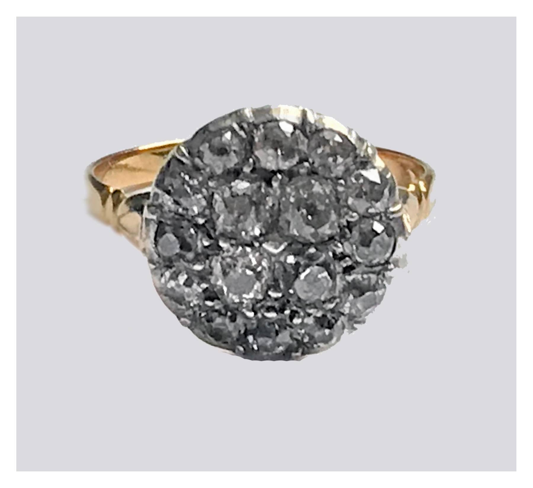 Georgian Diamond cluster Ring, English C.1800. The Diamond cluster set with sixteen old cut diamonds, closed back setting, split shoulders, double reed shank. Ring Size: 8. Total Item Weight: 4.45 grams. Stamped 18ct on interior of shank. 