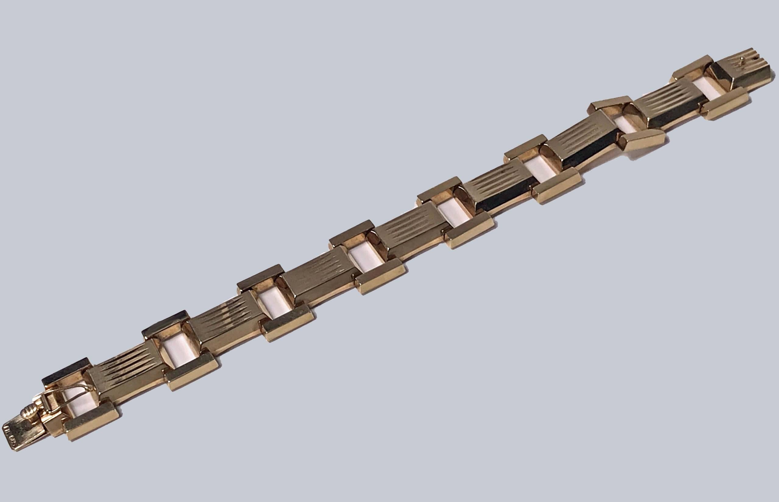 1940s 14K rose gold Bracelet. The bracelet comprising rectangular chunky quadrilateral links with groove design inter spaced with borders of plain open polished links terminating with tongue clasp fastener conforming to link. Stamped FB 585.  Width