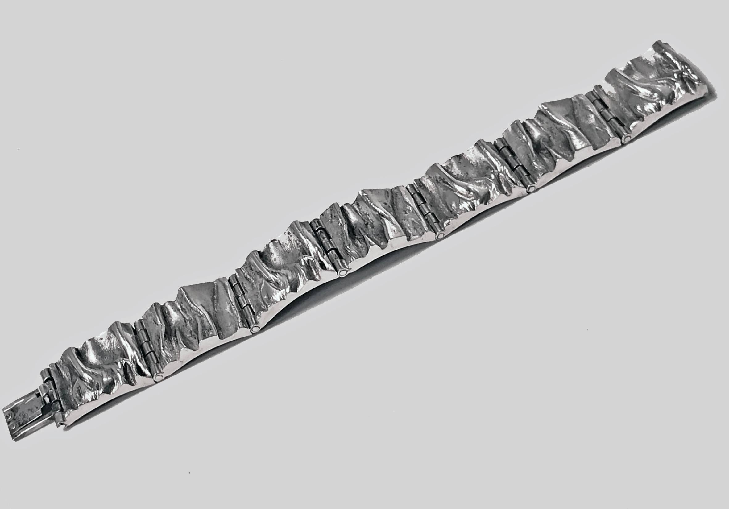 Scandinavian Silver Bracelet, Matti J. Hyvarinen of Sirokoru, Finland 1973, English import marks. The handmade hinged bracelet of organic design textured links. Fully hallmarked. Length: 7 inches. Weight: 49.96 grams.